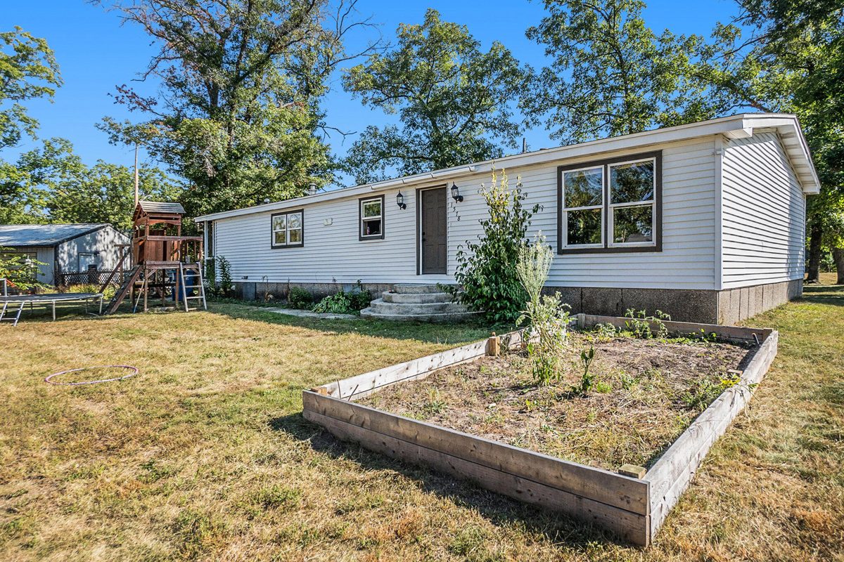 Single-story home with a raised garden bed in the front yard